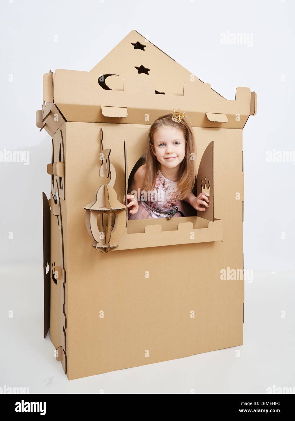 The princess play with cardboard castle tower. Stock Photo