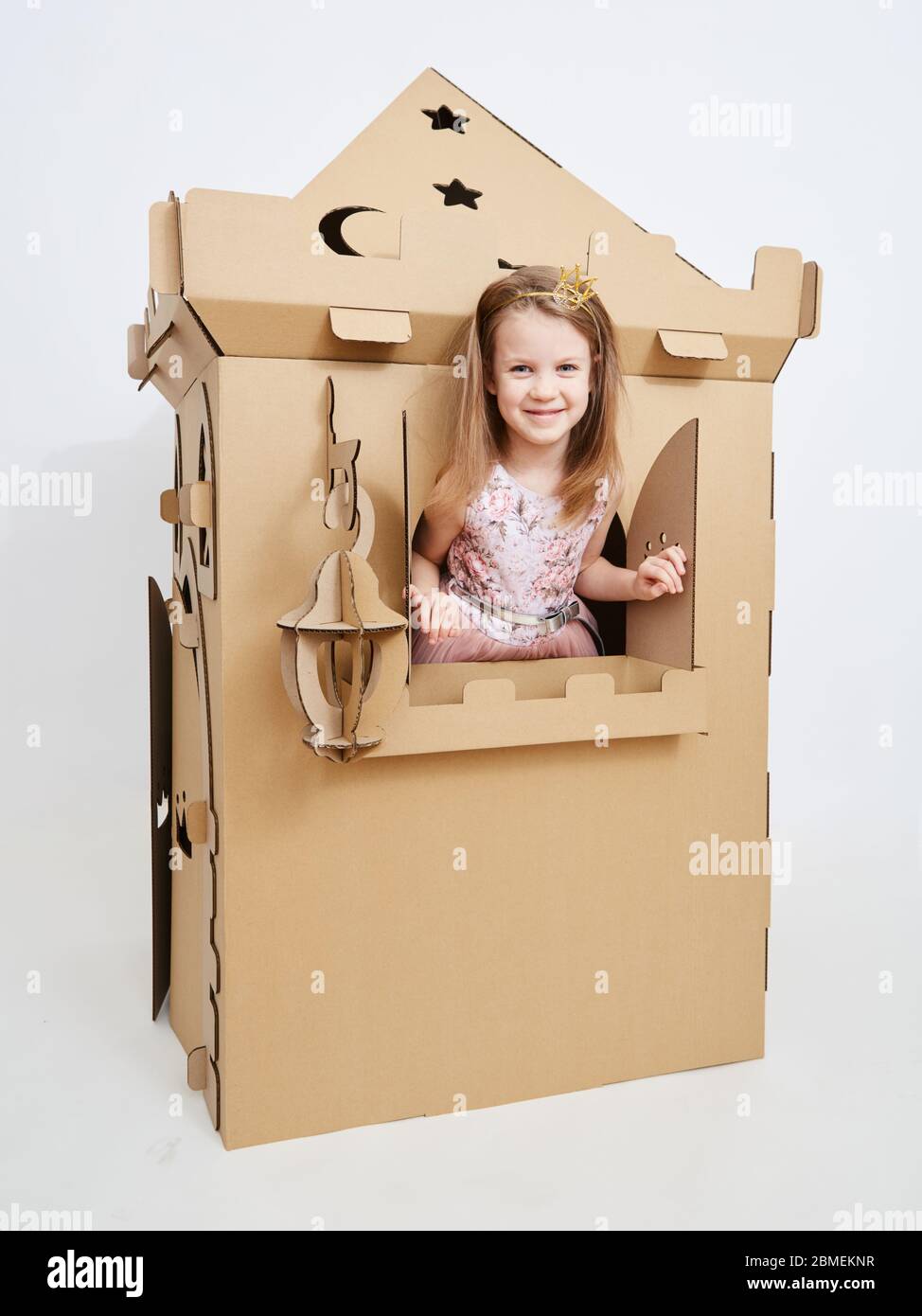 The princess play with cardboard castle tower. Stock Photo