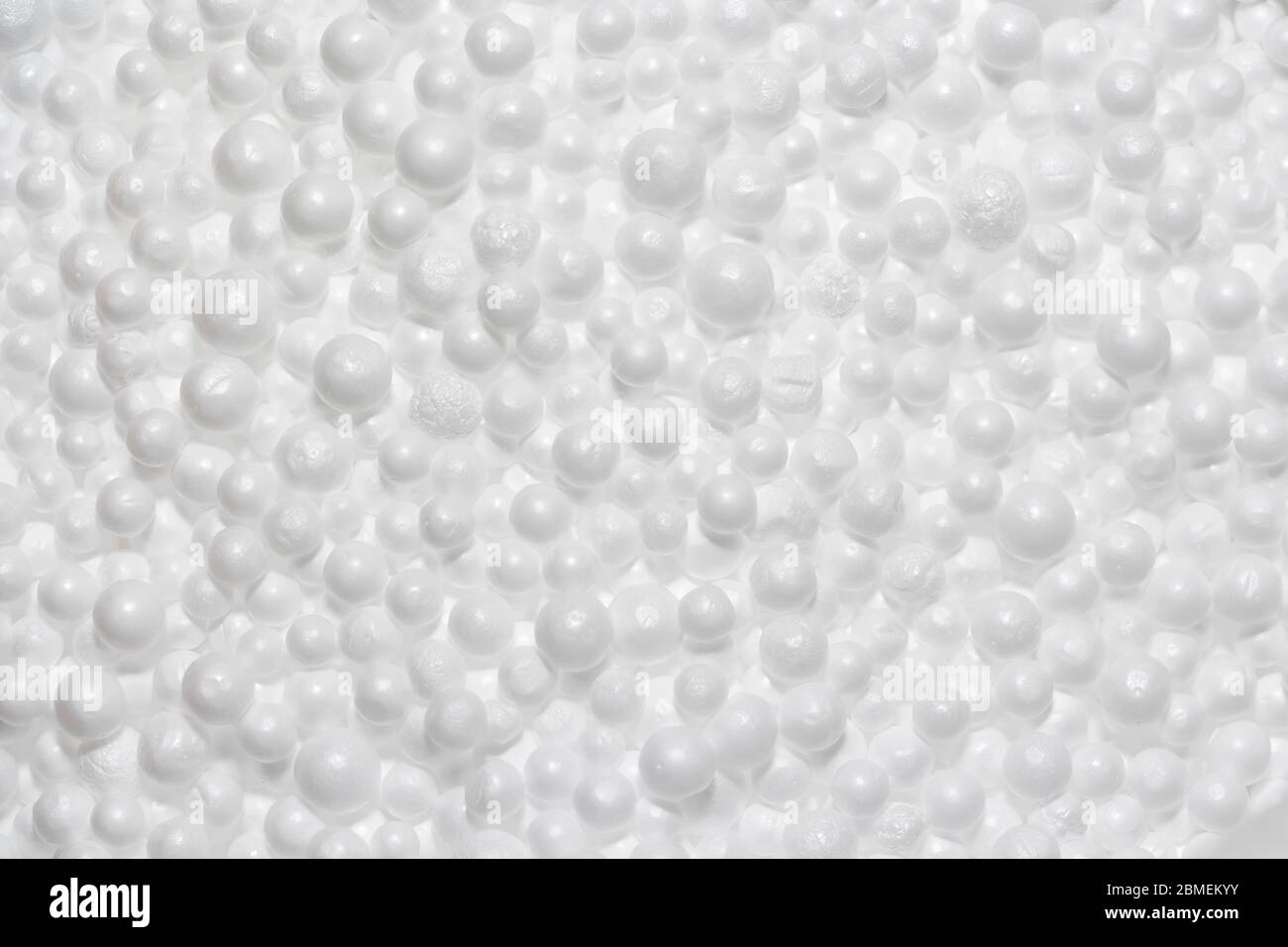 Round Styrofoam balls in my hands, the texture for the background. Environmental protection. Stock Photo