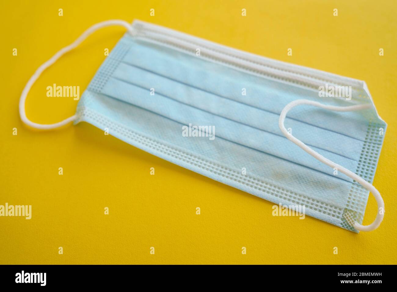 Medical face mask on yellow background Stock Photo