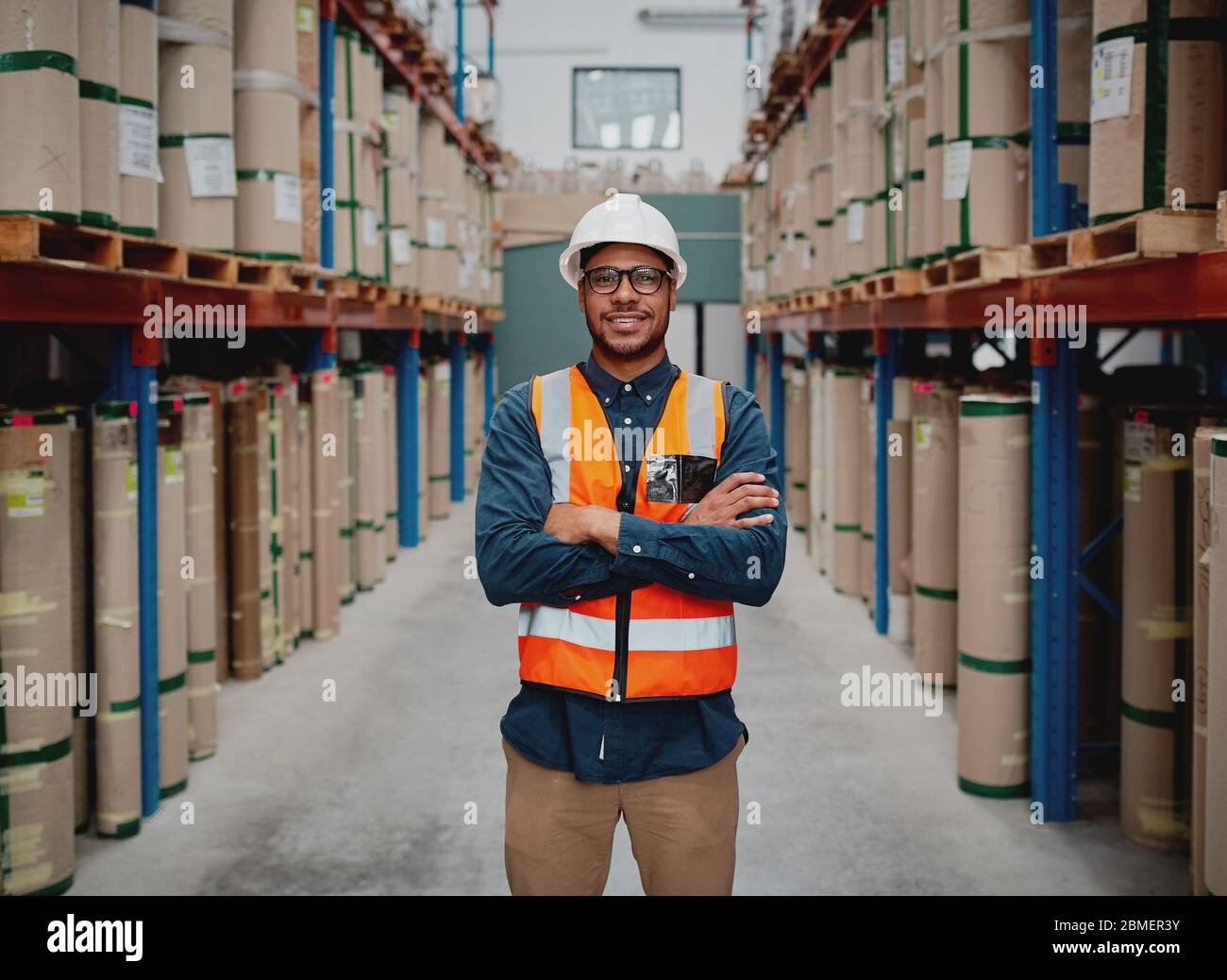 Successful manufacturing unit worker standing in warehouse distribution