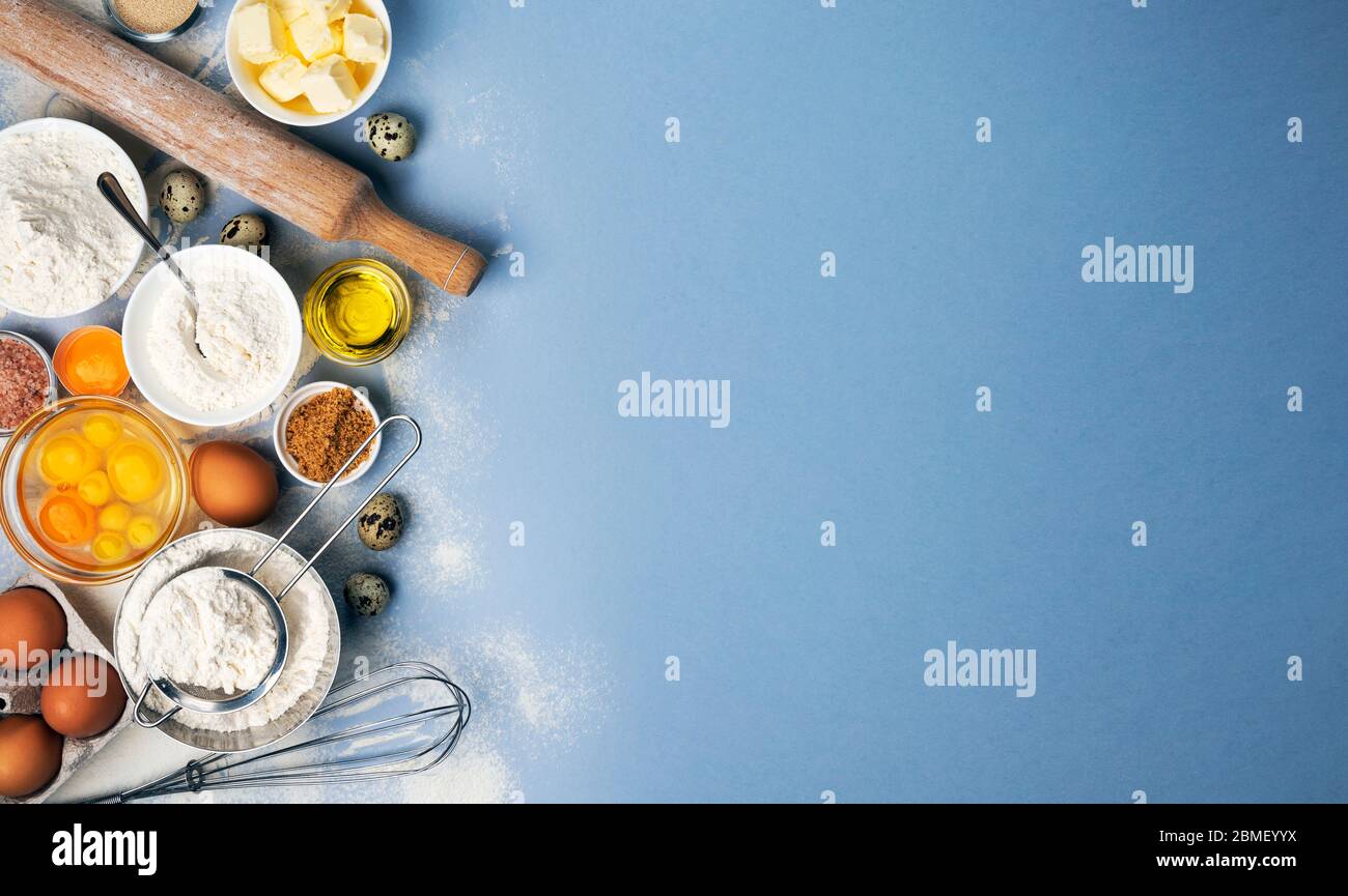 Baking ingredients on blue color background, top view Stock Photo