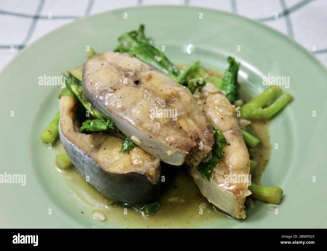 Thai Cuisine and Food, Stir Fried Fillet Pangasius Fish or Striped Catfish with Chinese Kale. Stock Photo
