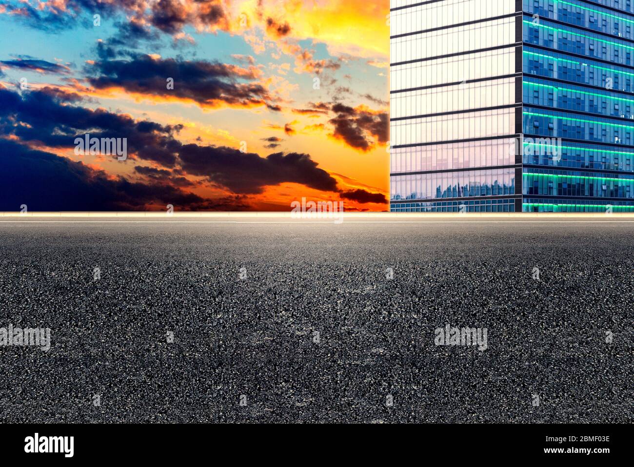 Empty asphalt pavements and modern urban landmarks in the setting sun Stock Photo