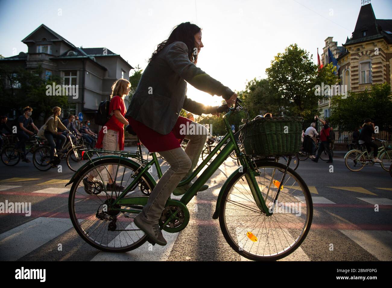 Ljubljana, Slovenia, May 8, 2020: A protester rides her bicycle  during an anti-government protest amid the coronavirus crisis. Following whistleblower's revelations of corruption in the government of Janez Janša and accusations of its undemocratic rule over five thousand people rode bicycles around government buildings in sign of protest. Stock Photo