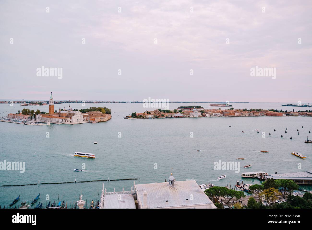Aerial view from huge cathedral bell tower San Marco Campanile, on The main pier of gondolas, near Piazza San Marco and San Giorgio Maggiore is one of Stock Photo