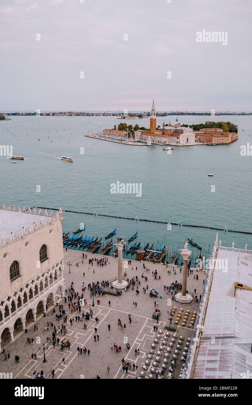Aerial view, from huge cathedral bell tower San Marco Campanile, on The main pier of gondolas near Piazza San Marco and San Giorgio Maggiore is one of Stock Photo