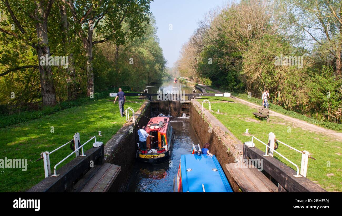 Newbury, England - April 22, 2011: Narrow boats pass through Hamstead Lock on the Kennet and Avon Canal. Stock Photo