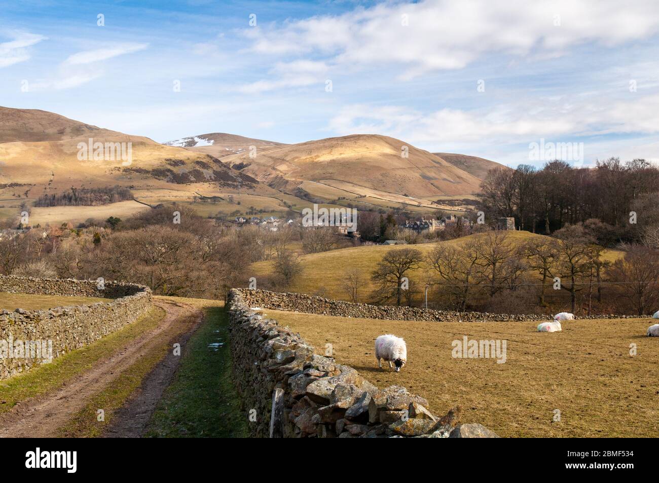 The snow-capped Howgill Fells hills rise bind the town of Sedbergh in the Yorkshire Dales National Park. Stock Photo