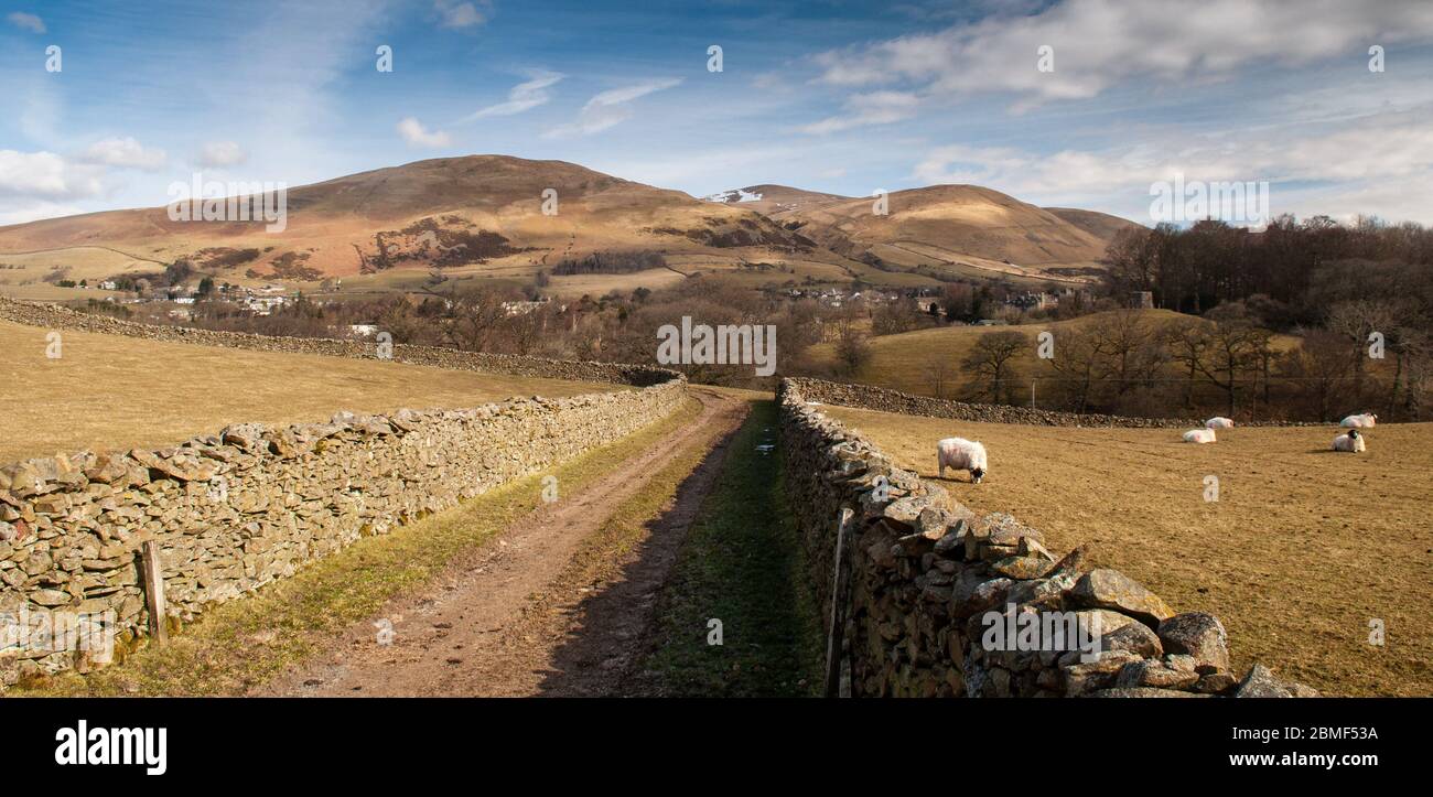 The snow-capped Howgill Fells hills rise bind the town of Sedbergh in the Yorkshire Dales National Park. Stock Photo