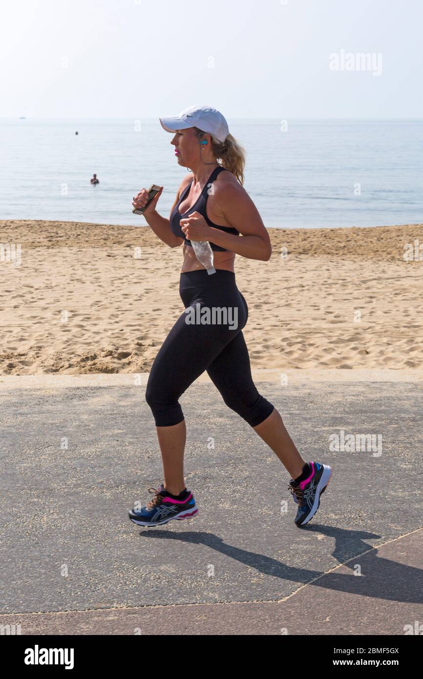 Woman jogger on hot day hi-res stock 