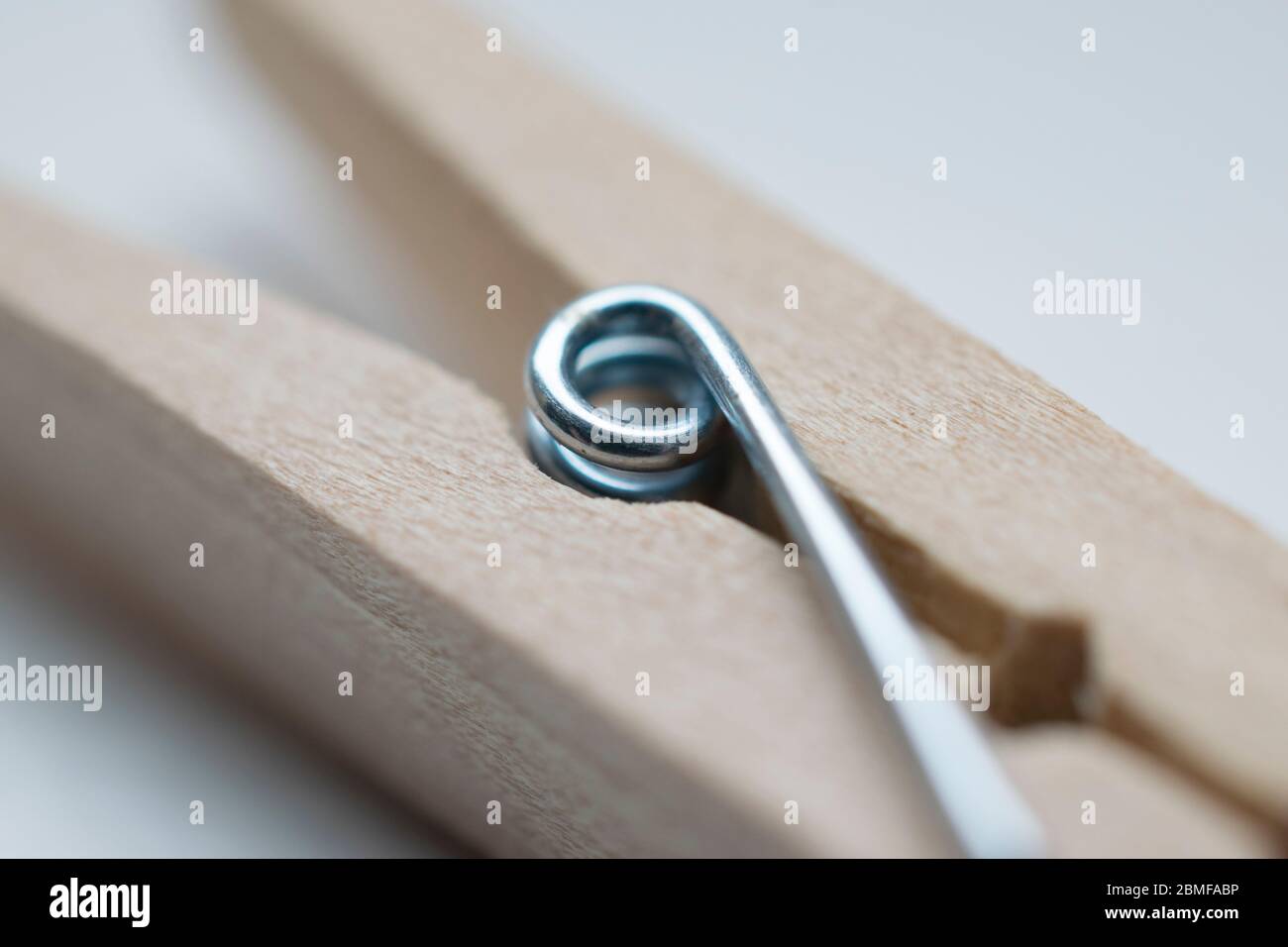 Wooden clothes peg with spring Stock Photo