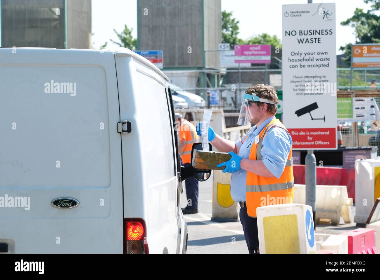 Hereford, Herefordshire UK - Saturday 9th May 2020 - Herefordshire Council has re-opened two recycling centres to the public today across the county. Recycling centre staff wearing protective PPE instruct visitors on the site protocol as they arrive. Recycling Centres have been shut since Britain entered lockdown at the end of March 2020. Photo Steven May / Alamy Live News Stock Photo
