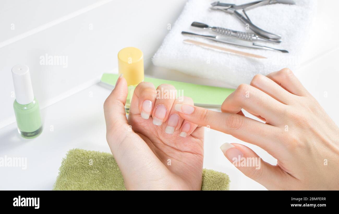 Premium Photo | Closeup of a girl doing a manicure in a beauty salon nail  care manicurist corrects the applied varnish with a thin brush cosmetic  procedure