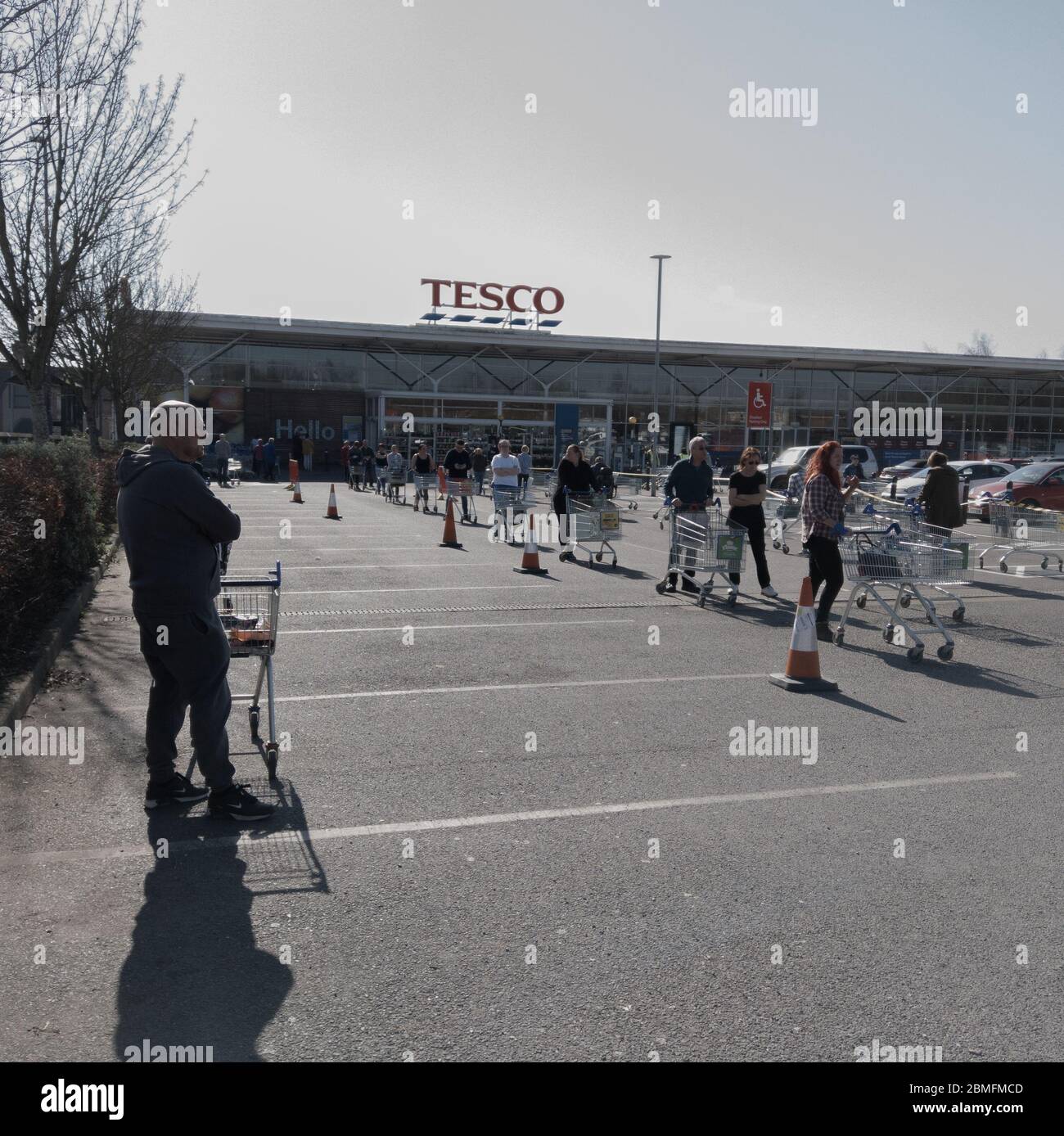 Tesco, Clowne, Chesterfield / U.K - March 26 2020 People queuing up to do the weeks shopping in the U.K. This is midweek at the near the start of the Stock Photo
