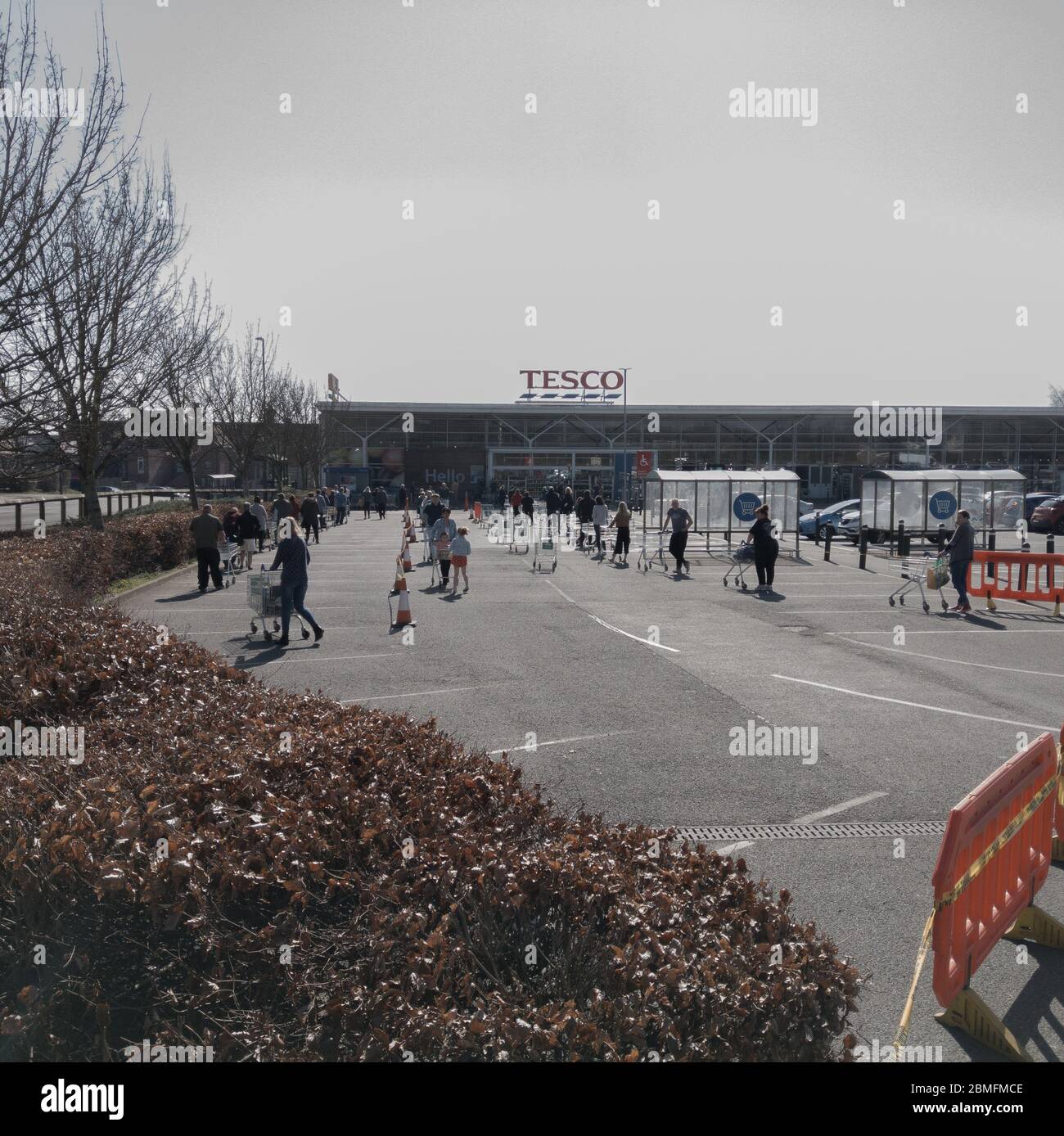Tesco, Clowne, Chesterfield / U.K - March 26 2020 People queuing up to do the weeks shopping in the U.K. This is midweek at the near the start of the Stock Photo