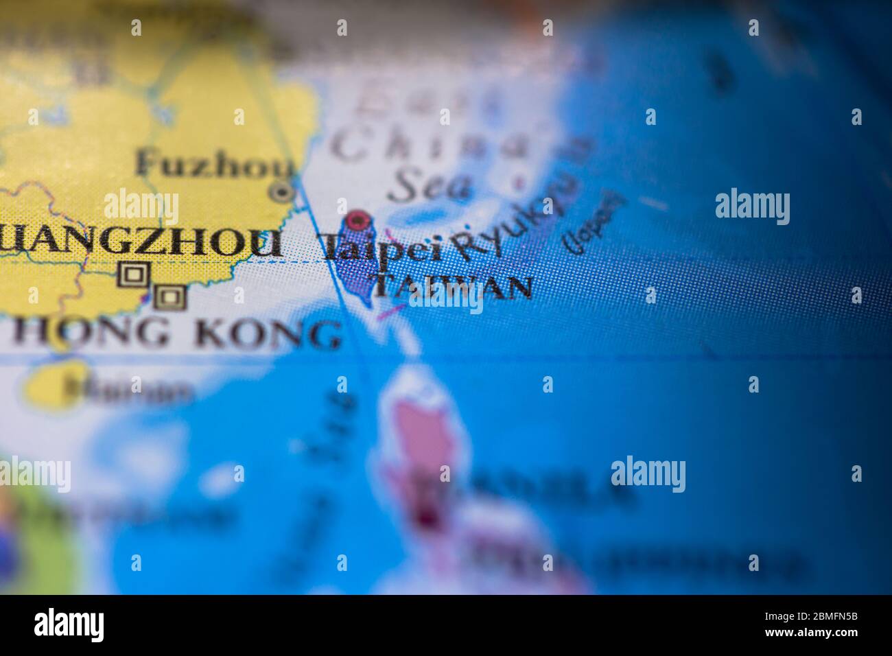 Shallow depth of field focus on geographical map location of country Taiwan in Asia continent on atlas Stock Photo