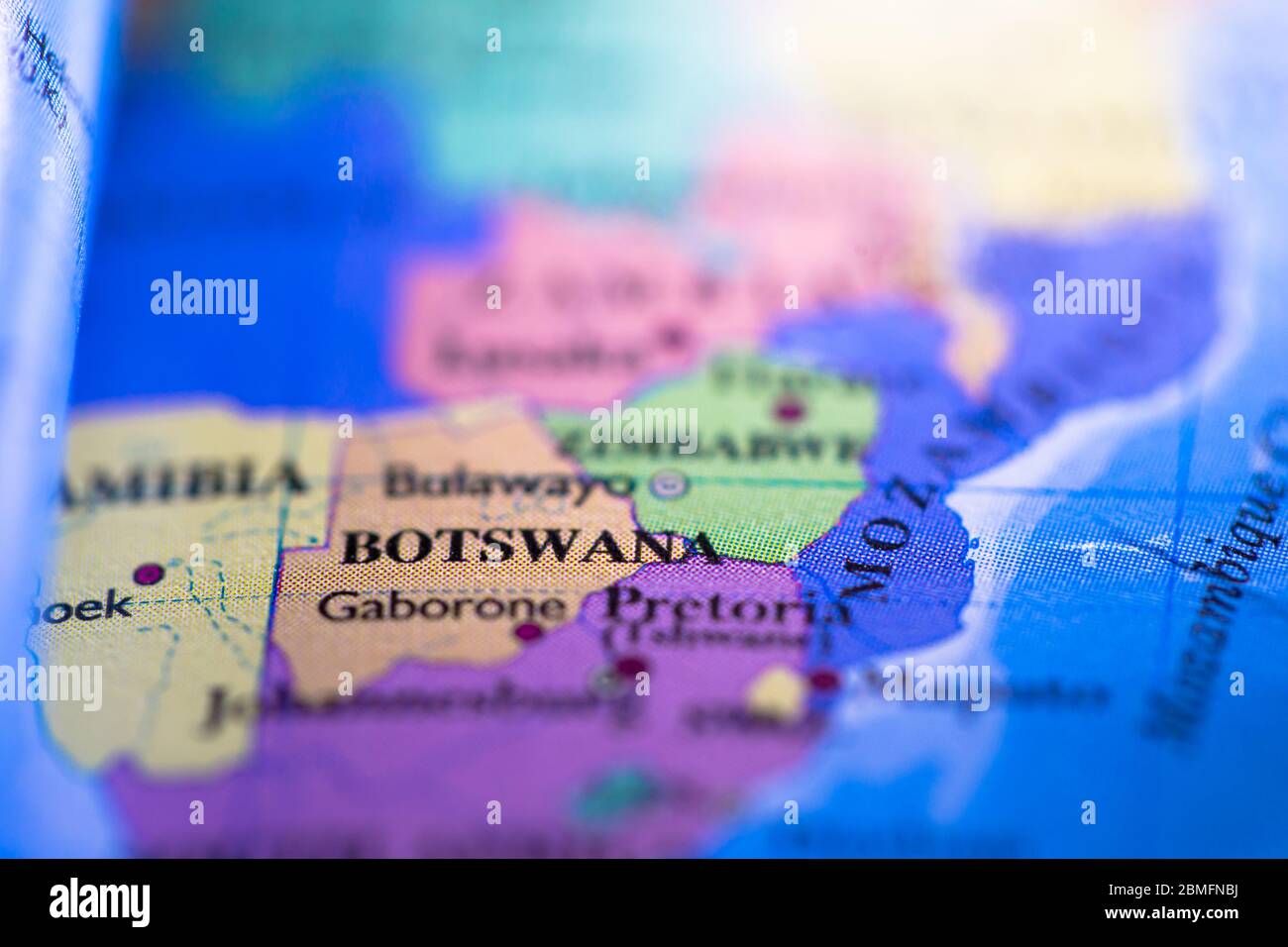 Shallow depth of field focus on geographical map location of country Botswana in Africa continent on atlas Stock Photo