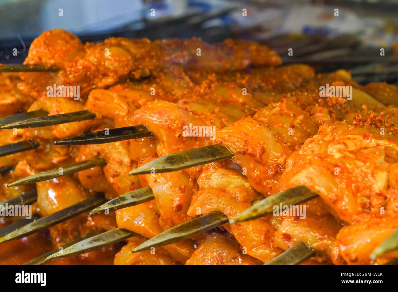 Roasted meat cooked at barbecue. Grilled kebab cooking on metal skewer
