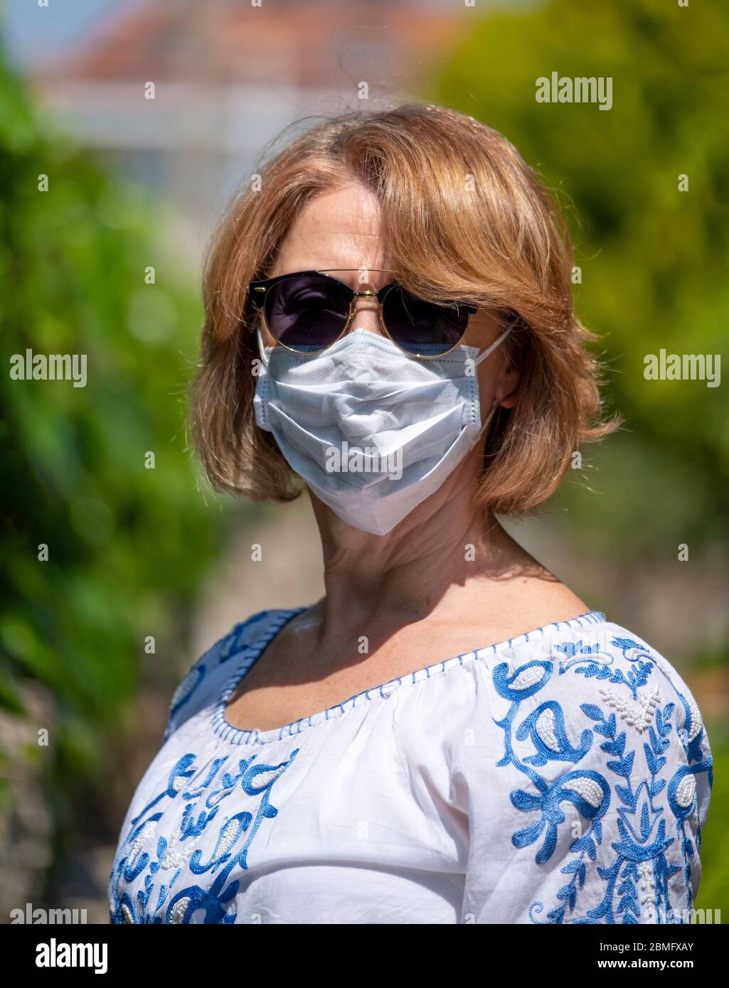Mugla, Turkey - April 13, 2020: Woman wearing a protective mask to protect herself from corona virus on April 13, 2020. Stock Photo