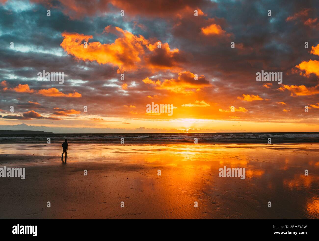 Silhouette of a person at Westward Ho beach, Devon Stock Photo