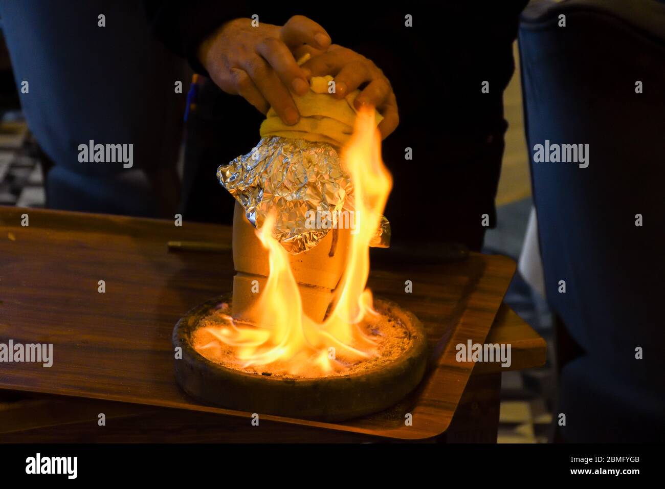 Traditional Turkish Testi Kebab - Tandir - Pottery Kebab cooked in clay pt over fire in Istanbul. Stock Photo