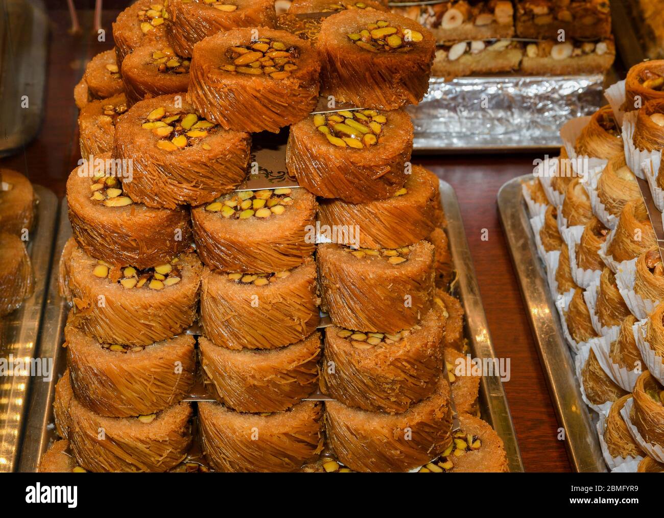 Traditional baklava sweet dessert delights, cataif pastry during hotel brunch buffet outside outdoor in the garden by the pool. Fresh Food Buffet Brun Stock Photo