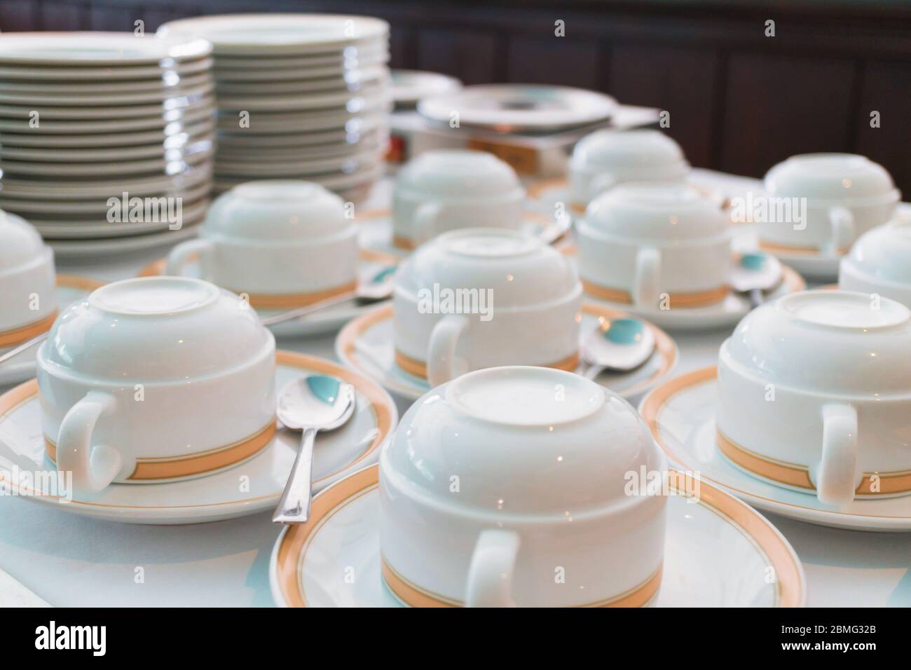 Group of ceramic cup and plates stacked on the table for tea or coffee service Stock Photo