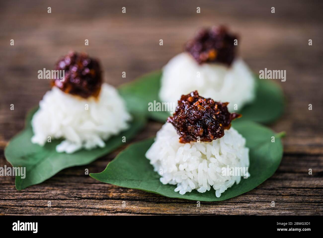 Spicy chili paste with steamed rice on wood background Stock Photo
