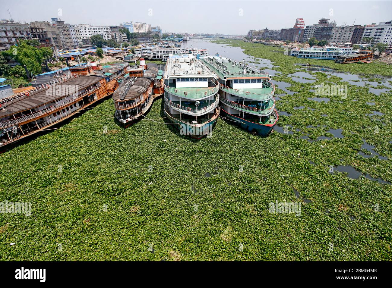 BIWTA steamers sit idle in the Buriganga at Simson Road terminal in the capital as operation of passenger vessels remain suspended for an indefinite p Stock Photo