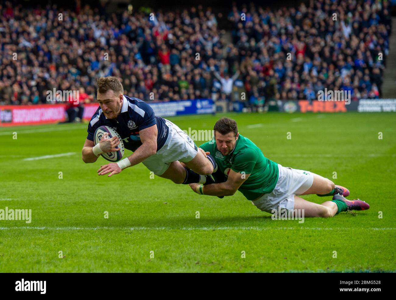 Stuart Hogg of Scotland scores a try with Robbie Henshaw of Ireland failing to tackle him during the RBS Six Nations International, Scotland v Ireland. Stock Photo
