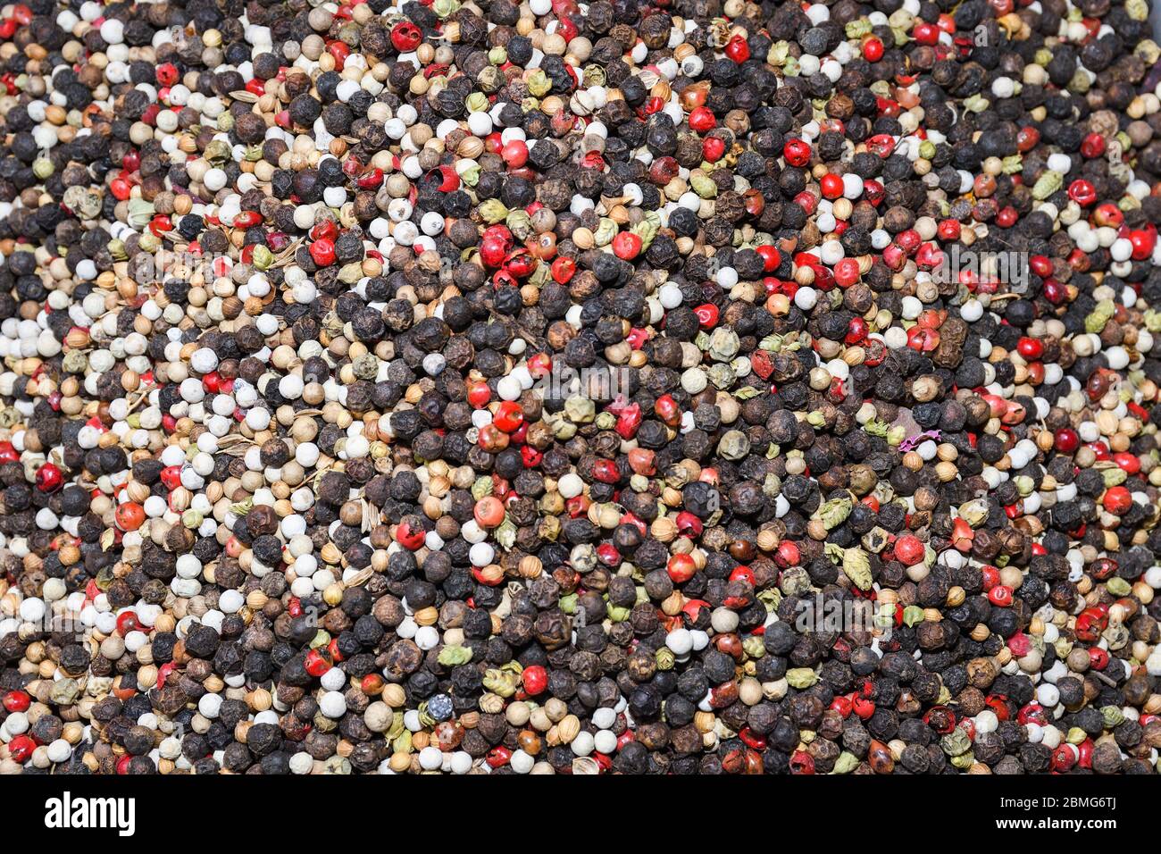 Mixed peppercorns background. Different colored peppercorns, close up