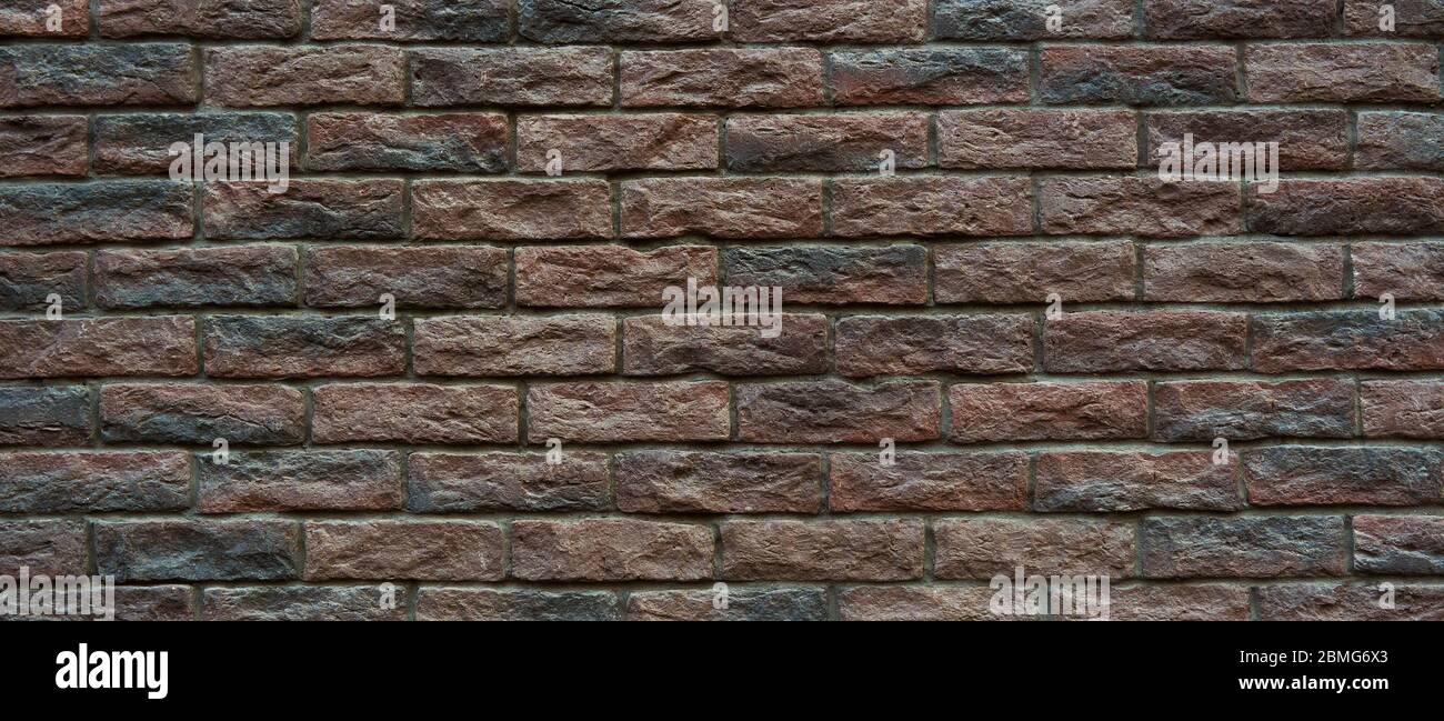 Brown brick wall. Hand made brick wall. Stock Photo