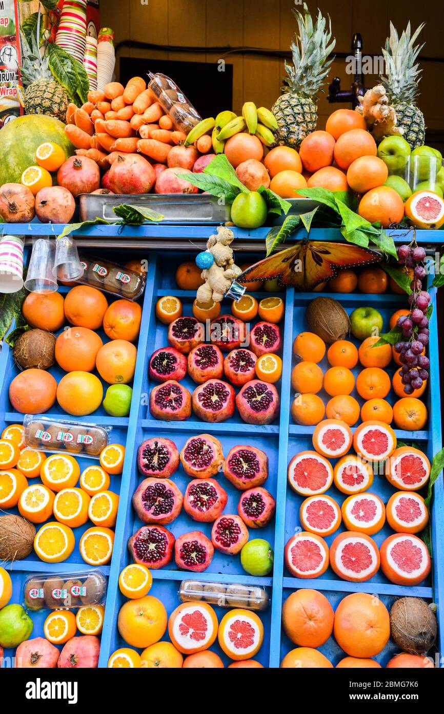 Juice bar background concept. Fresh exotic fruits wall Juicing Fresh  Pomegranates At Farmers Market Stall Stock Photo - Alamy