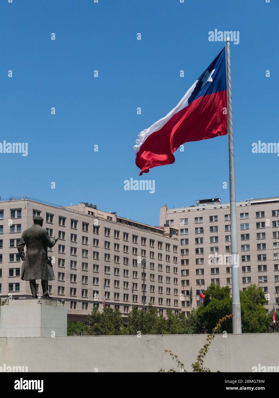 Chileans walking near the giant flag on Avenida La Alameda with the citizenship Square, in downtown Santiago de Chile. Stock Photo