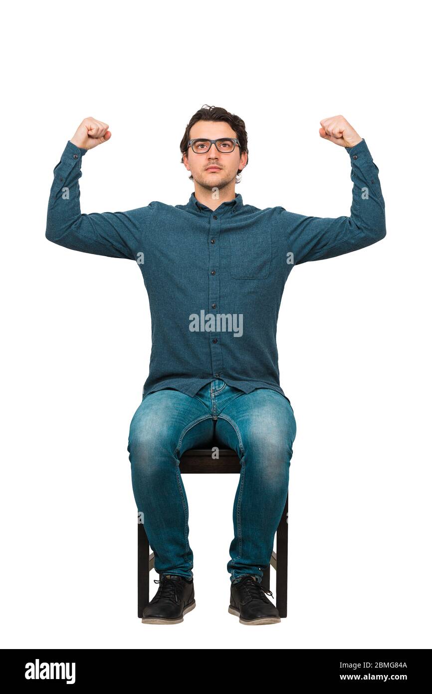 Full length confident businessman seated on chair, flexes muscles imagine superpower, isolated on white. Business person, looking determined. Personal Stock Photo