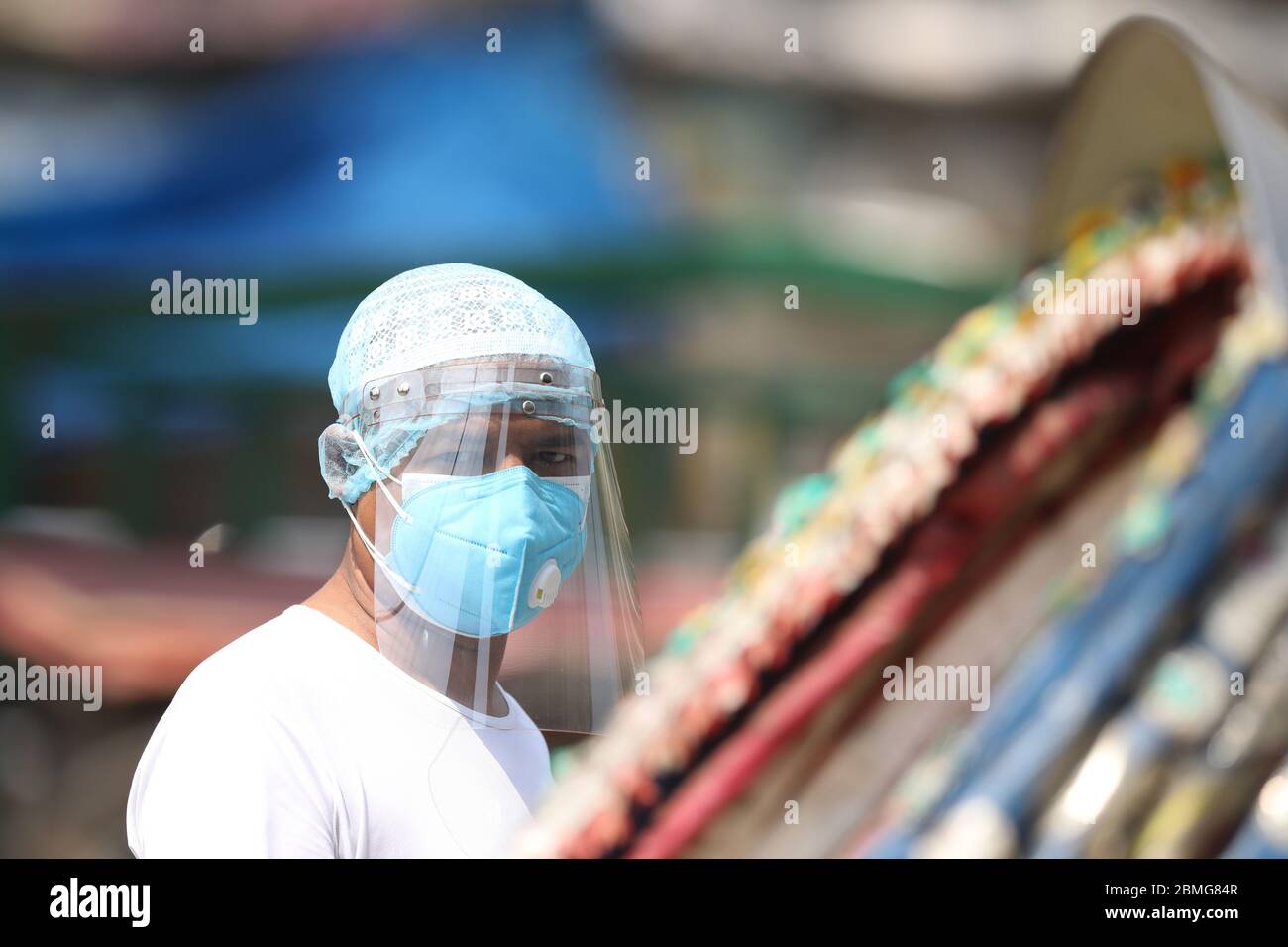 A man looks on while wearing a face mask as a preventive measure during the Coronavirus (COVID-19) crisis.Bangladesh has confirmed deaths of eight more Covid-19 patients in the last 24 hours, taking the country's death toll to 214. Besides another 636 people tested positive for the deadly disease over the same period, pushing up the total number of confirmed cases to 13,770. Stock Photo