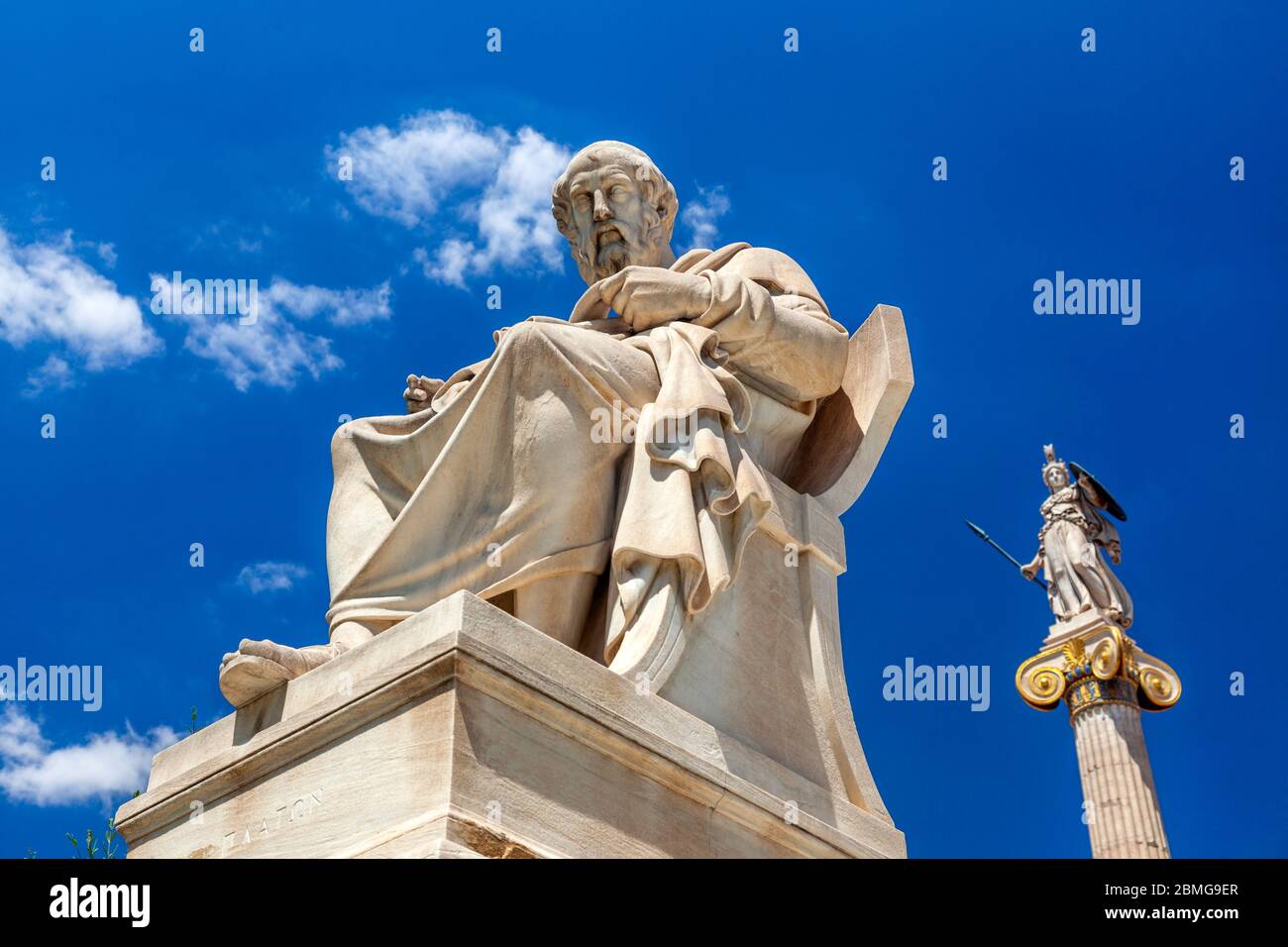 Statue of Plato in the foreground and the ancient goddess Athena at the background, in Athens, Greece. Stock Photo