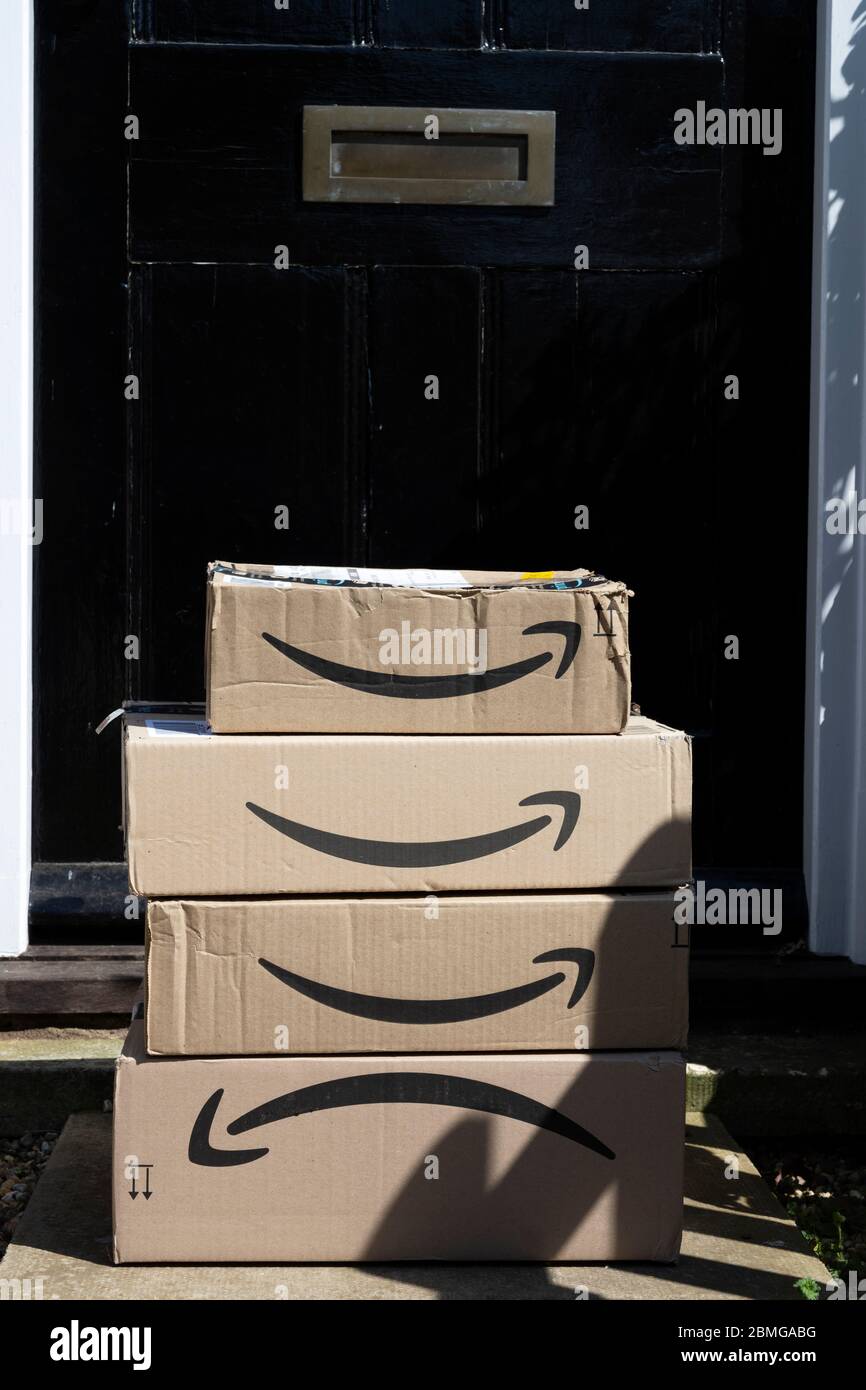 Amazon cardboard product delivery boxes on a doorstep Stock Photo