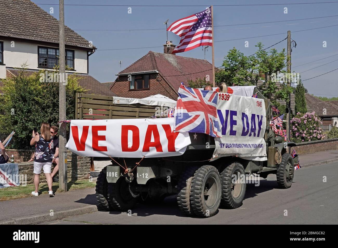 USA preserved military truck decorated VE day Union Jack & American Stars & Stripes flag calling at 2020 street celebrations parties Essex England UK Stock Photo