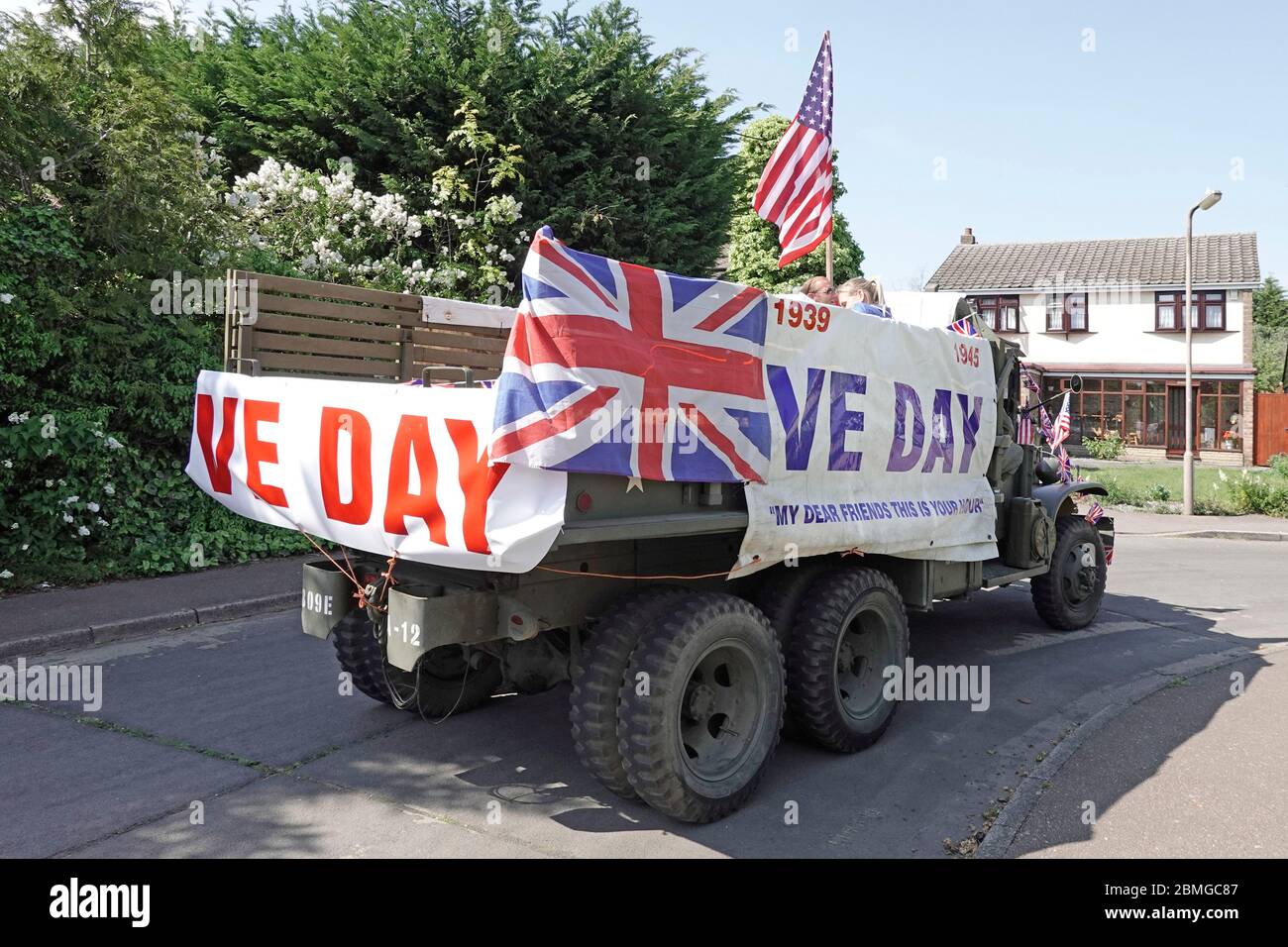 USA preserved military truck decorated VE day Union Jack & American Stars & Stripes flag calling at 2020 street celebrations parties Essex England UK Stock Photo