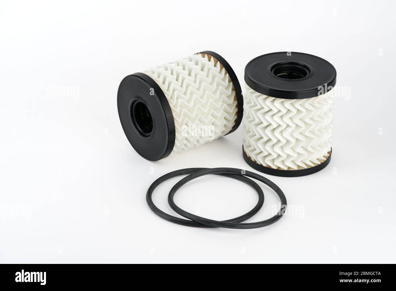 Isolate. Two oil filter cartridges and gaskets on a white background. Closeup. A high
