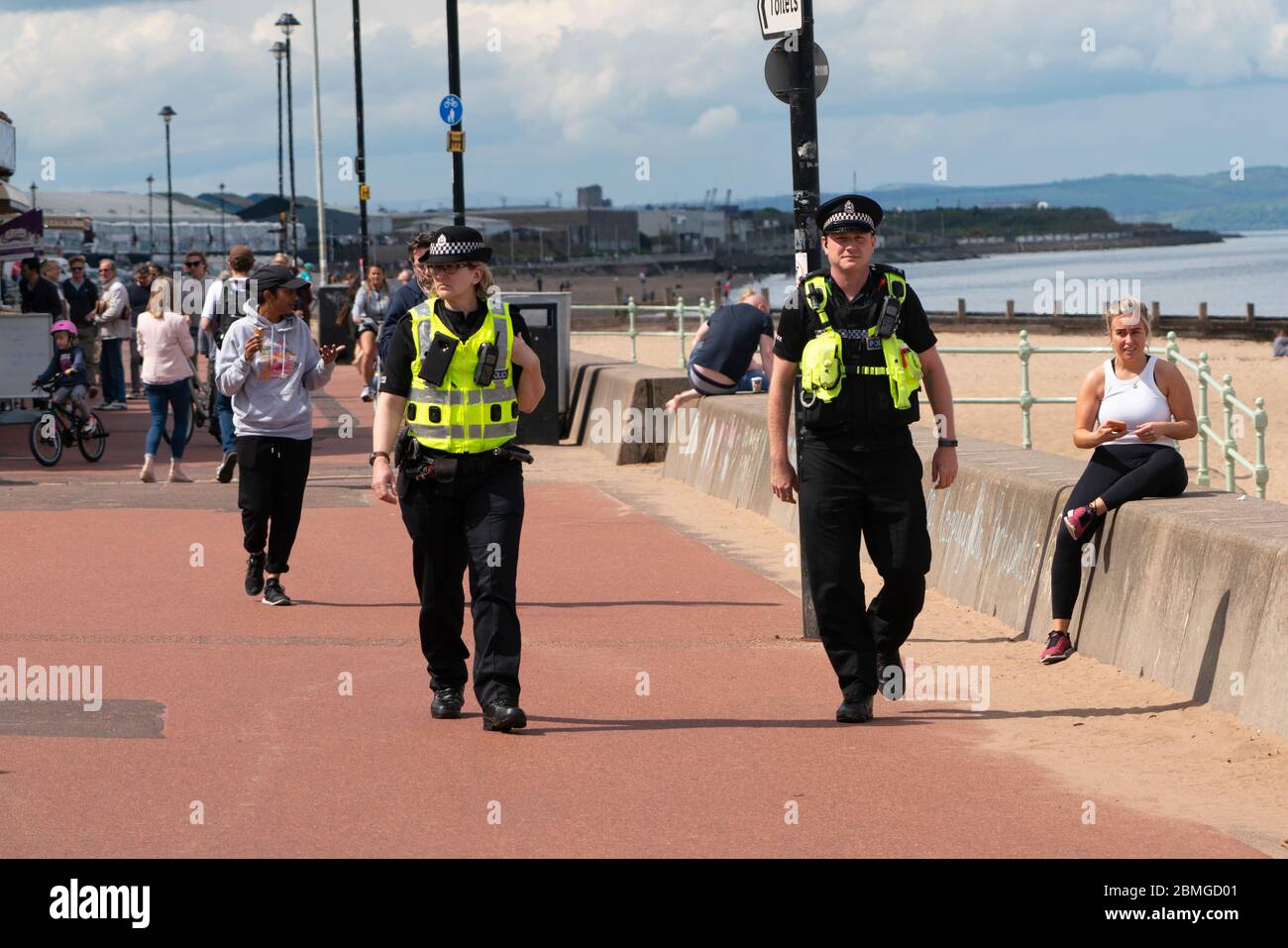 Portobello, Scotland, UK. 9 May 2020. Images from holiday weekend Saturday afternoon during Covid-19 lockdown on promenade at Portobello. Promenade and beach were relatively quiet with a low key police presence. Pictured; Police patrol on the promenade.  Iain Masterton/Alamy Live News Stock Photo