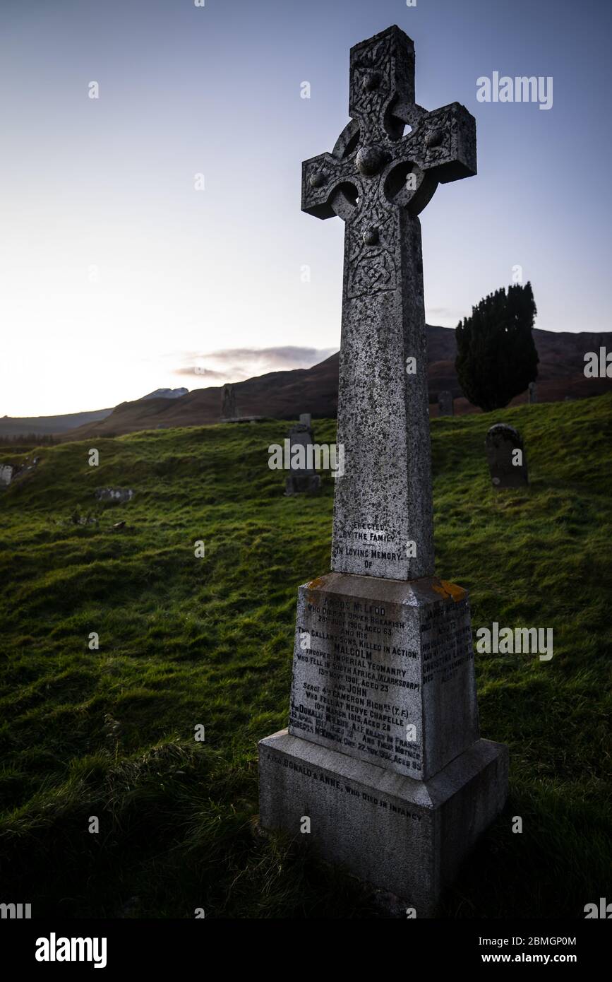 A celtic cross headstone in the graveyard of the abandoned Cill Chriosd church near Boradford, on the Isle of Skye.  Taken near sunset. Stock Photo