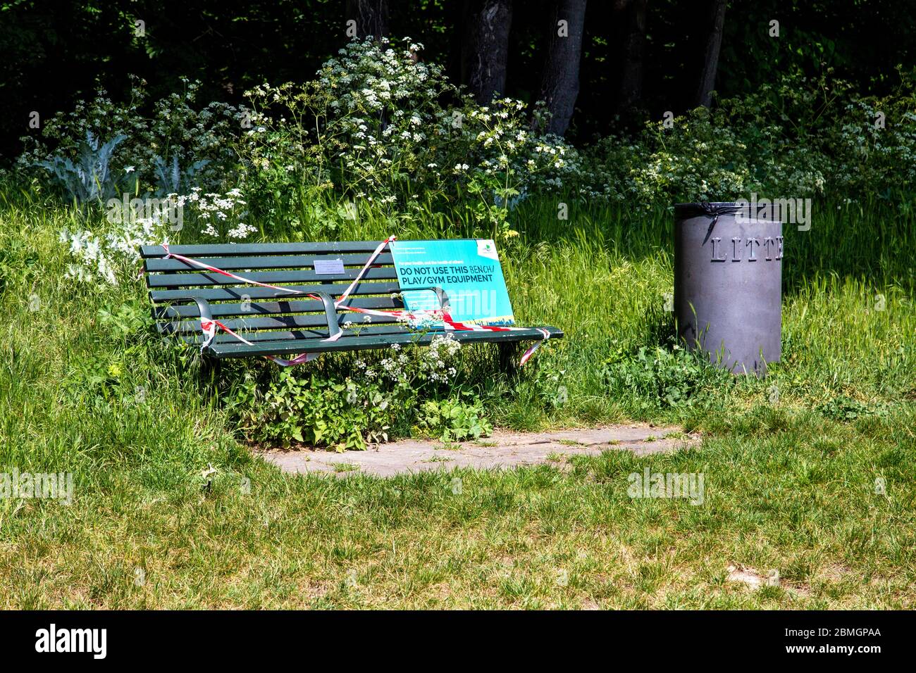 9th May 2020, London, UK - Bench taped over due to government restrictions to prevent people from using it during the Coronavirus outbreak lockdown at Tower Hamlets Cemetery Park, sign saying 'Do Not Use this Bench / Play / Gym Equipment' Stock Photo