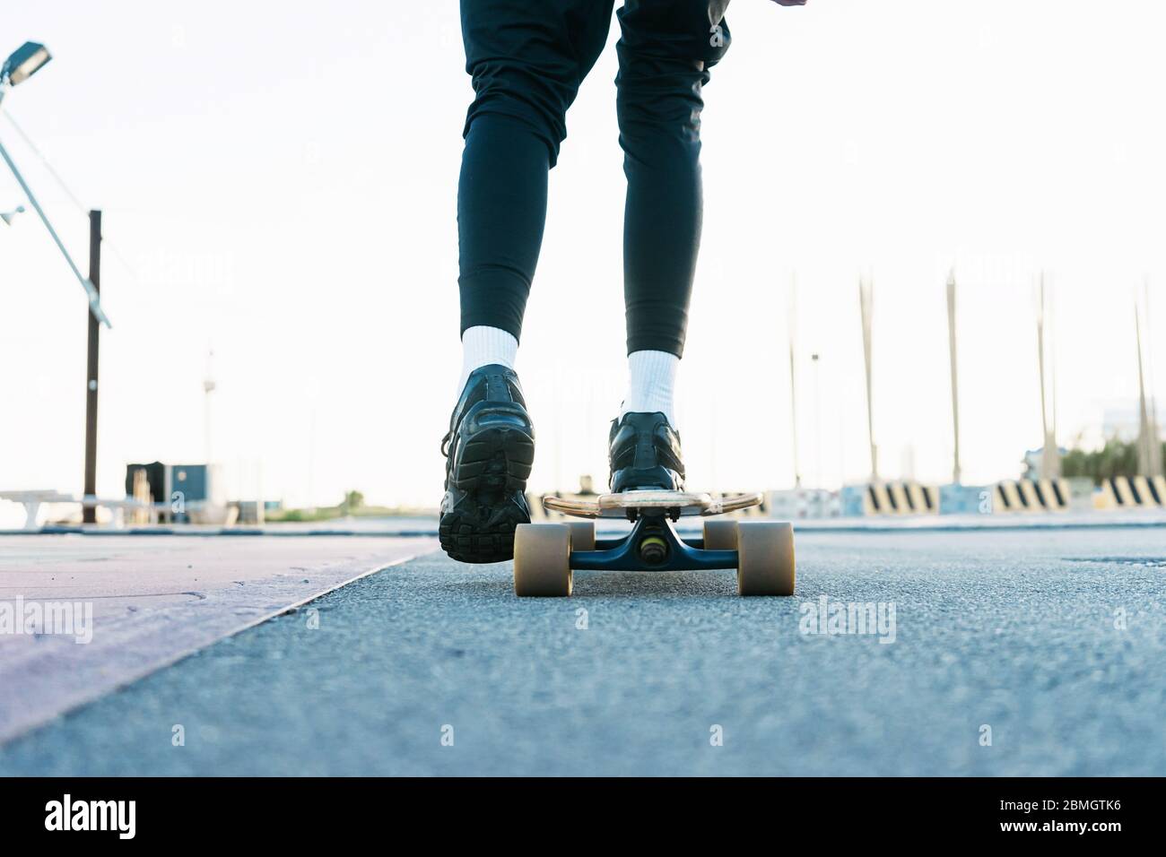 Close up of legs of unrecognizable teenage girl standing on skateboard  outdoors on playground Stock Photo - Alamy