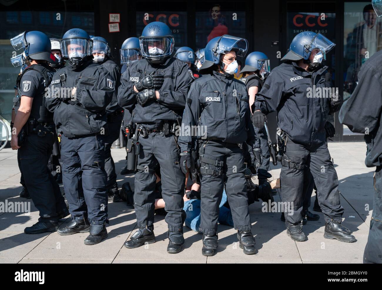 Berlin, Germany. 09th May, 2020. Policemen hold a man on the ground during a demonstration on Alexanderplatz. Several hundred people gathered at Alexanderplatz on Saturday afternoon for an unannounced meeting. The police were on the scene with several task forces. According to a spokeswoman, police officers pointed out to the demonstrators the regulations for containing corona infections. Credit: Christophe Gateau/dpa/Alamy Live News Stock Photo