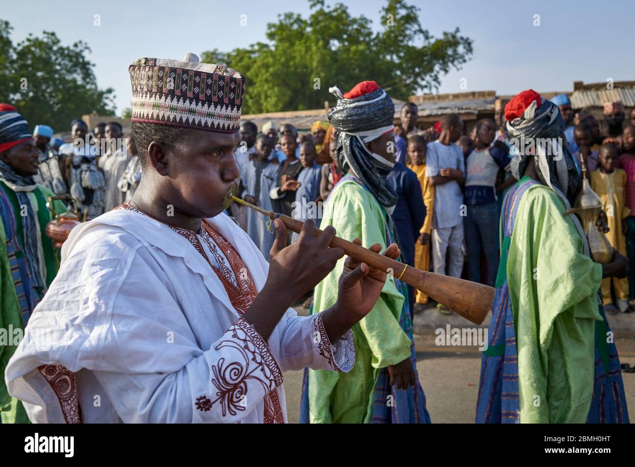 Musician playing traditional Nigerian trumpet during the celebration of