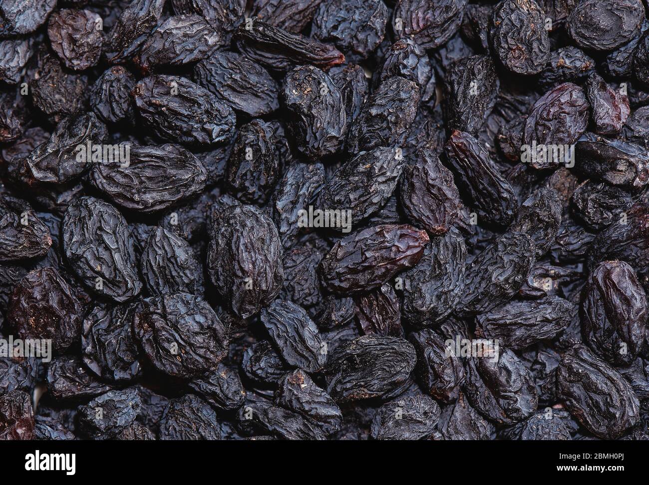 Background, dried black sultana grapes, raisins Stock Photo Alamy