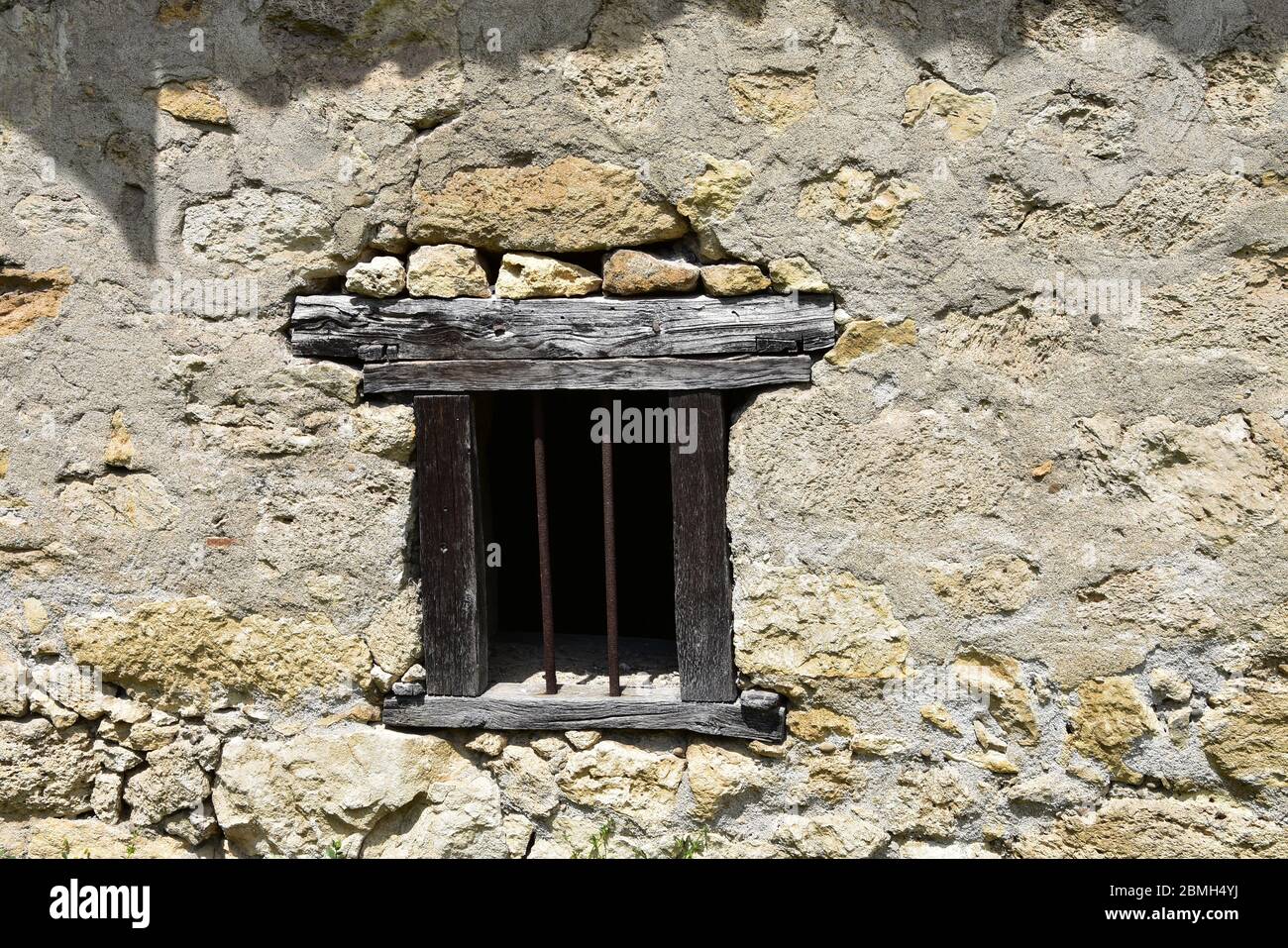 Antique wooden rusty metal window on stone wall Stock Photo - Alamy